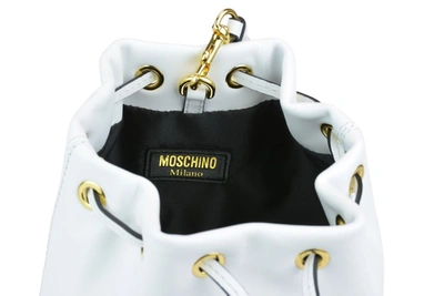 Shop Moschino Logo Printed Drawstring Shoulder Bag In White