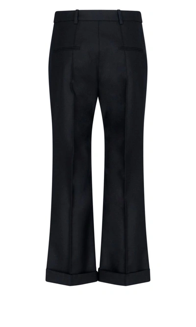 Shop Saint Laurent Flared Trousers In Black