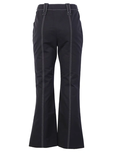 Shop Givenchy Contrast Stitch Flared Trousers In Black