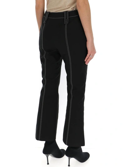 Shop Givenchy Contrast Stitch Flared Trousers In Black