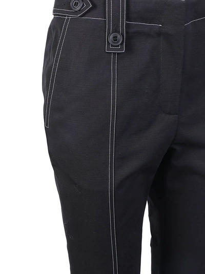 Shop Givenchy Contrast Stitch Flared Trousers In Black