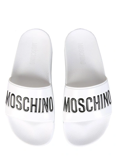 Shop Moschino Logo Slide Sandals In White
