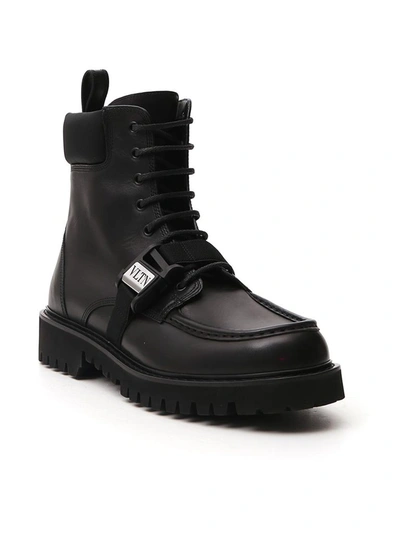 Shop Valentino Vltn Buckled Combat Boots In Black