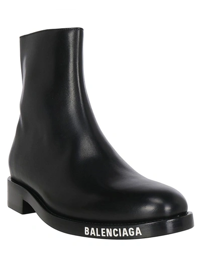 Shop Balenciaga Logo Printed Ankle Boots In Black