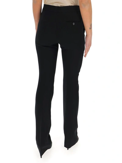 Shop Moschino Pressed Crease Flared Pants In Black