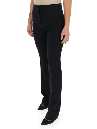 Shop Moschino Pressed Crease Flared Pants In Black