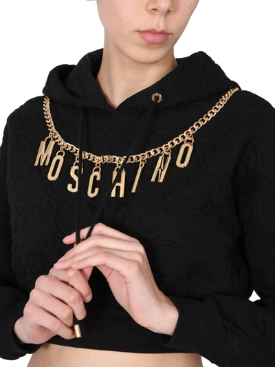 Shop Moschino Logo Chain Hooded Cropped Sweatshirt In Black