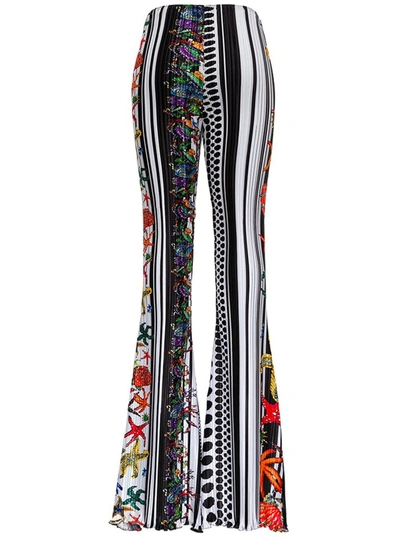 Shop Versace Graphic Printed Flared Pants In Multi