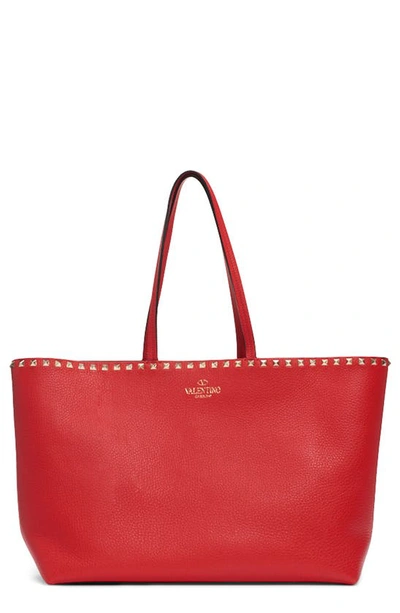 Shop Valentino Rockstud Leather Tote In Red