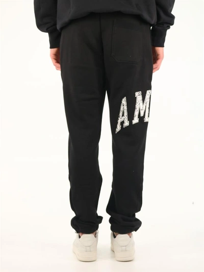 Shop Amiri Trousers Black