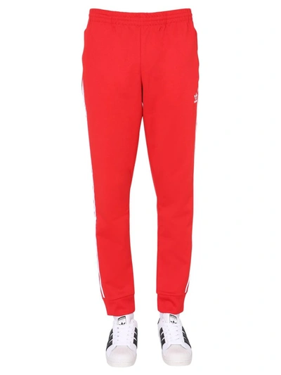 Shop Adidas Originals Adicolor Classics Primeblue Sst Track Pants In Red