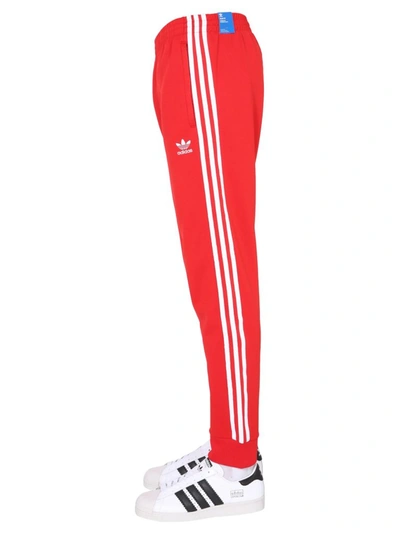 Shop Adidas Originals Adicolor Classics Primeblue Sst Track Pants In Red