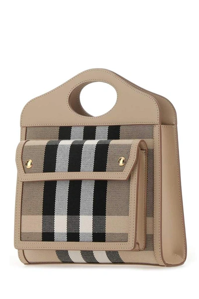 Shop Burberry Pocket Mini Handbag In Beige