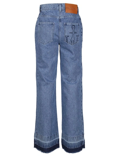 Shop Jw Anderson Bootleg Raw Hem Jeans In Blue