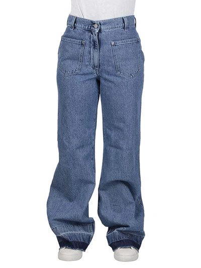 Shop Jw Anderson Bootleg Raw Hem Jeans In Blue