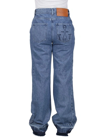 Shop Jw Anderson Bootleg Raw Hem Jeans In Blue