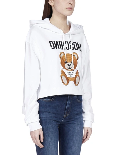 Shop Moschino Teddy Cropped Hooded Sweatshirt In White