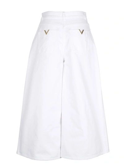 Shop Valentino Logo Plaque Wide Leg Jeans In White