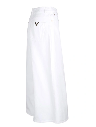 Shop Valentino Logo Plaque Wide Leg Jeans In White