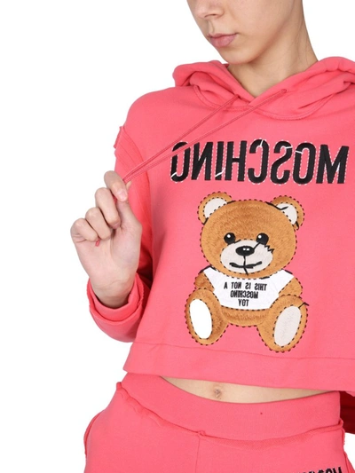 Shop Moschino Teddy Cropped Hooded Sweatshirt In Pink