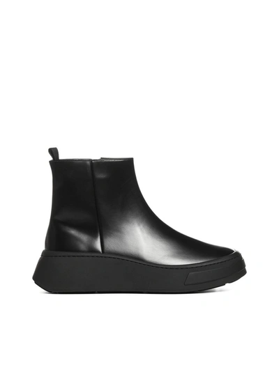 Shop Prada Wedged Ankle Boots In Black