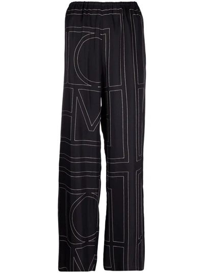 Shop Totême Monogram Silk Pyjama Bottoms In Black