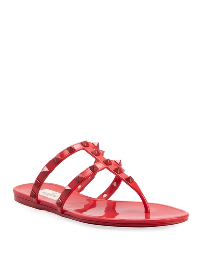 Shop Valentino Jelly Rockstud Flat Thong Sandals In 0ro Rosso V
