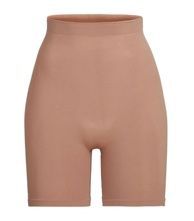Shop Skims Seamless Sculpt Mid-thigh Shorts In Brown