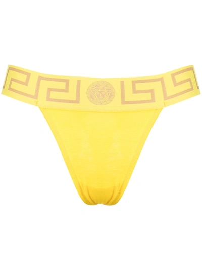 Shop Versace Greca Waistband Thong In Yellow