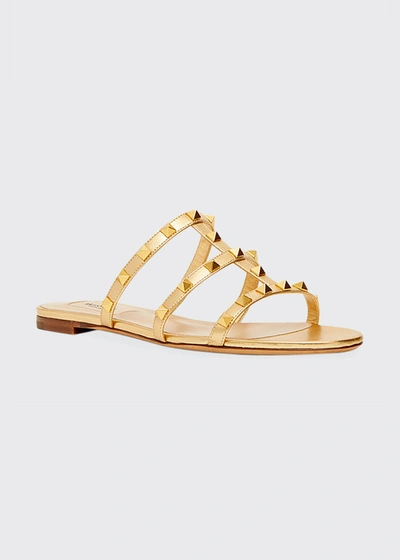 Shop Valentino Rockstud Caged Flat Slide Sandals In Gold