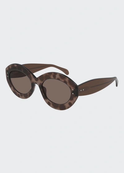 Shop Alaïa Oval Acetate Sunglasses In Brown