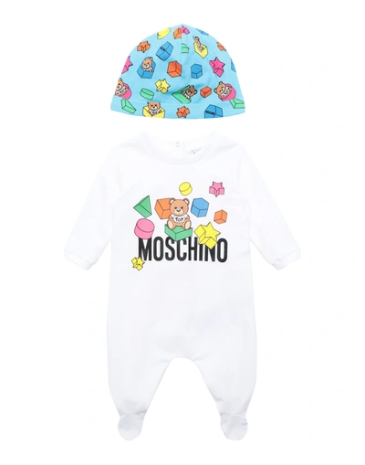 Shop Moschino Baby One-pieces In White