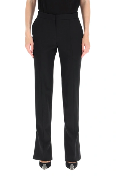 Shop Alexander Mcqueen Slashed Wool Trousers In Black