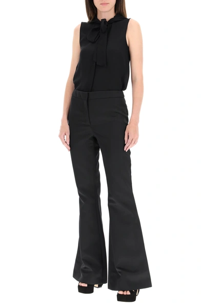 Shop Moschino Flared Satin Trousers In Black