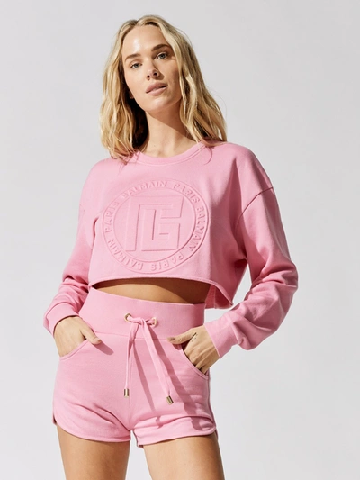 Shop Balmain Cropped Embossed Monogram Sweatshirt In Rose Clair