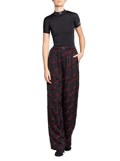 Shop Balenciaga Allover Logo Pajama Pants In Black Red