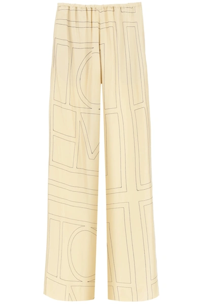 Shop Totême Monogram Embroidered Pajama Trousers In Ivory Monogram (beige)