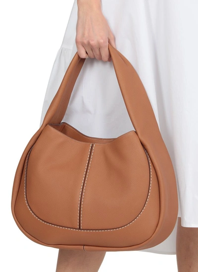 Shop Tod's Logo Embossed Hobo Bag In Brown