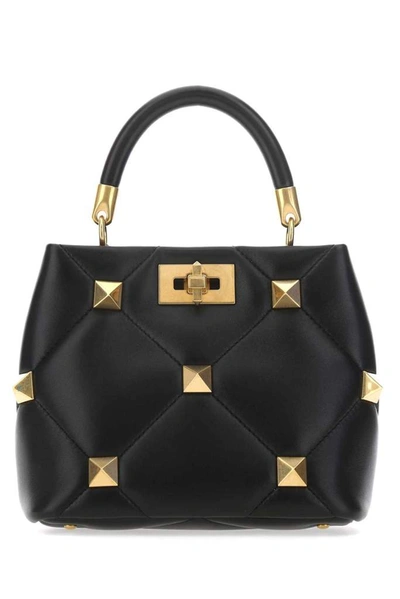 Shop Valentino Garavani Roman Stud Small Top Handle Bag In Black