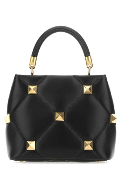 Shop Valentino Garavani Roman Stud Small Top Handle Bag In Black