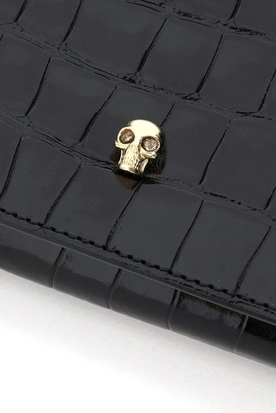 Shop Alexander Mcqueen Skull Embossed Clutch Bag In Black