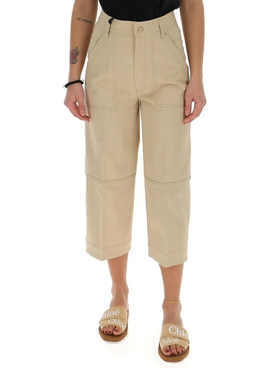 Shop Moncler Logo Patch Cropped Trousers In Beige
