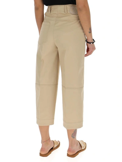 Shop Moncler Logo Patch Cropped Trousers In Beige