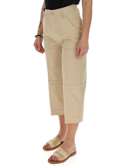 Shop Moncler Logo Patch Cropped Trousers In Beige