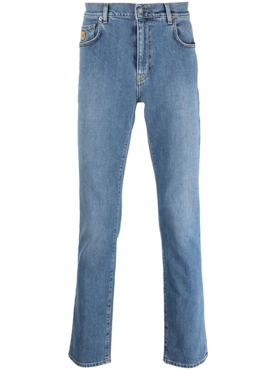 Shop Moschino Mid-rise Slim-fit Jeans In Blue