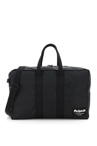 Shop Alexander Mcqueen Nylon Duffle Bag With Graffiti Logo Patch In Black Black Off W (black)