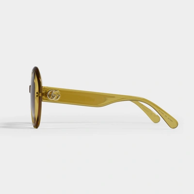 Shop Gucci Yellow Round Sunglasses