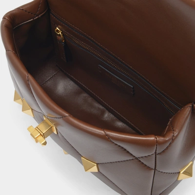 Shop Valentino Roman Stud Medium Shoulder Bag In Brown