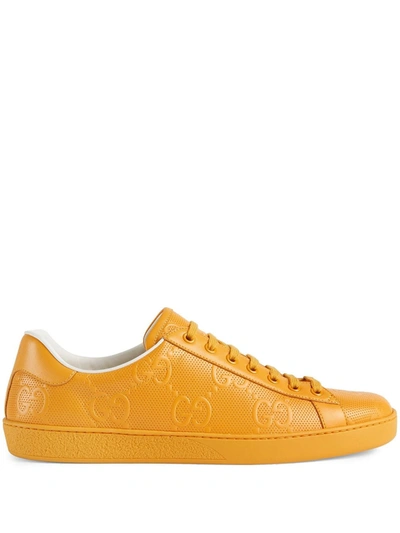 Shop Gucci Ace Gg Embossed Sneakers In Gelb