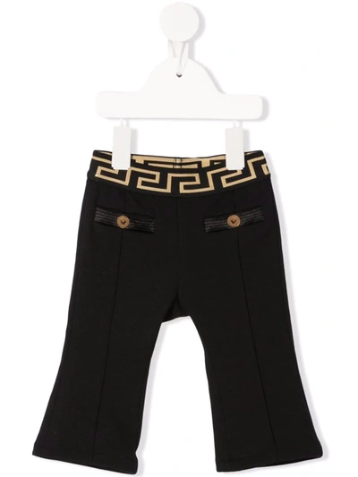 Shop Versace Greca-pattern Waistband Trousers In 黑色